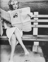 Marilyn Monroe photographed reading the paper in New York by Sam Shaw, 1957